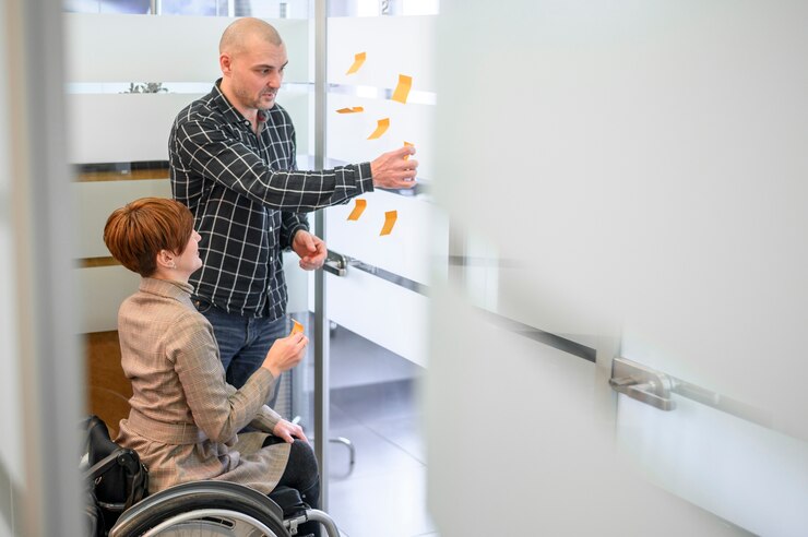 woman sitting wheelchair and talking with person for Ndis registered cleaning provider